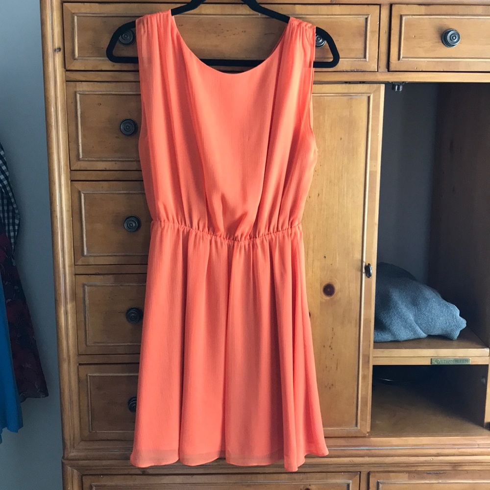 Orange sleeveless dress.